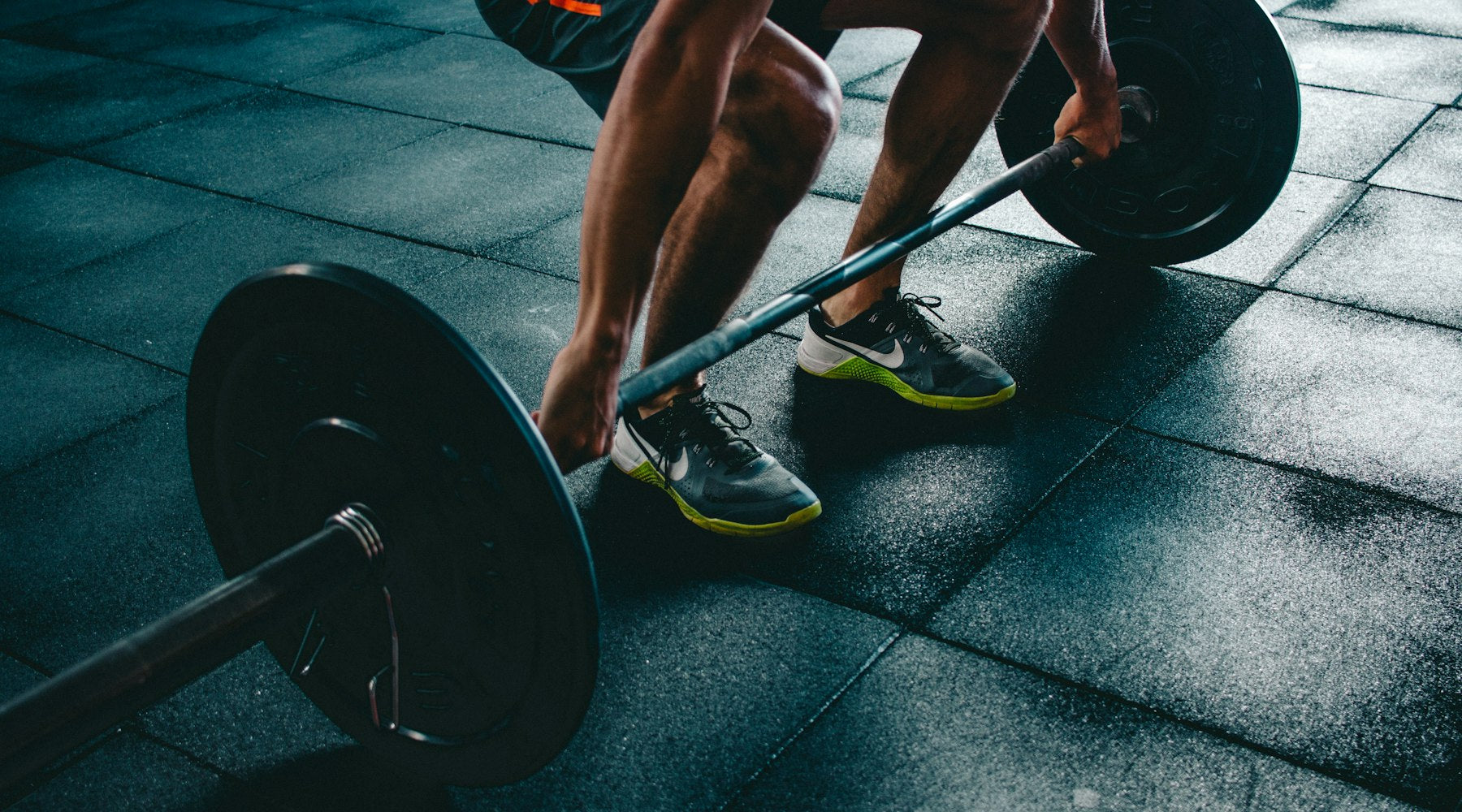 Runner performing single-leg strength exercises in a gym to prevent injury and improve performance