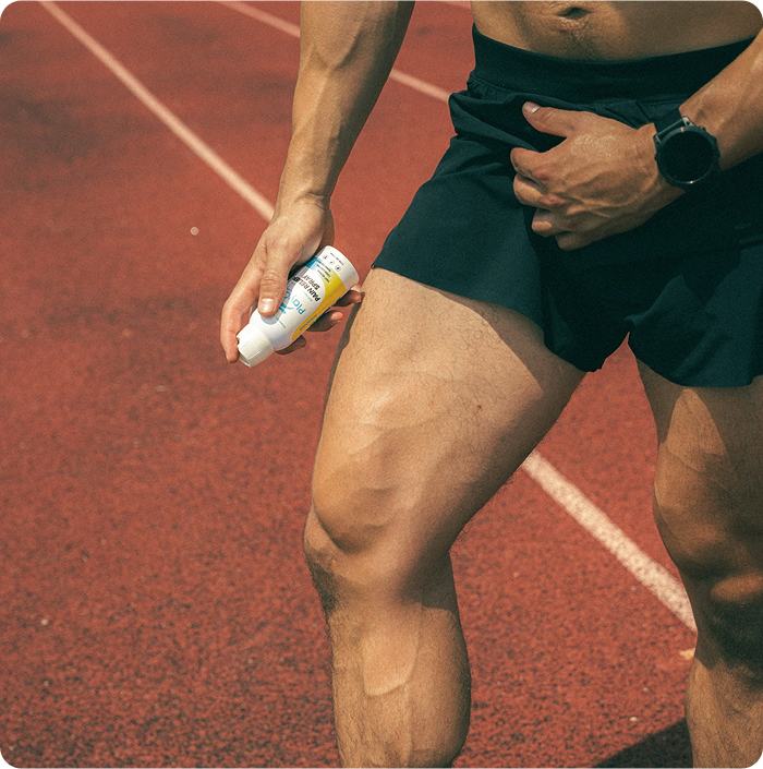 runner on track holding playon pain relief spray